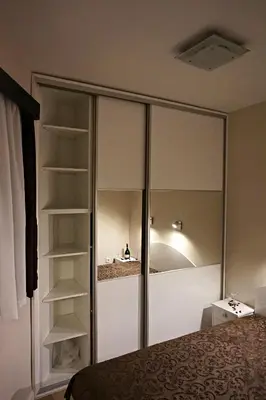 a bedroom with a large glass closet with shelves at Vila Plan 404 in Kopaonik