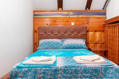 a bedroom with a bed with two towels on it at Fortezza rooms in Niš