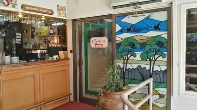 a shop with a stained glass door with a plant at Fortezza rooms in Niš