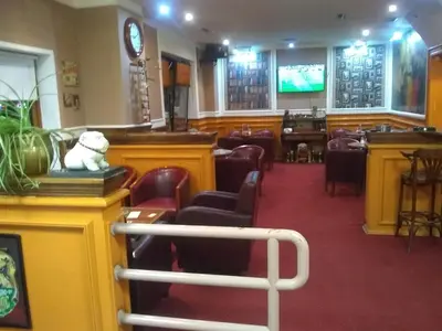 a restaurant with a teddy bear sitting on a bar at Fortezza rooms in Niš