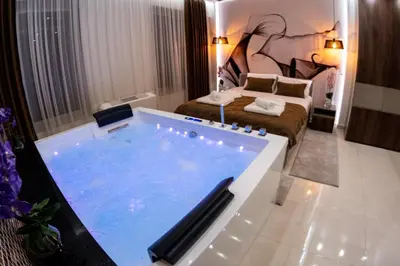 a hotel room with a large tub in a bathroom at Princ Apartment in Niš