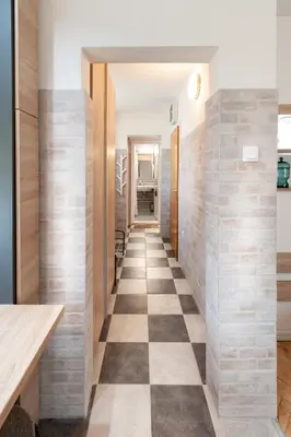 a hallway in a house with a checkered floor at Kuća Jankovića in Vrnjačka Banja