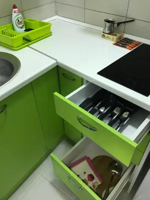a kitchen with green cabinets and a sink at La Apartamento in Jagodina