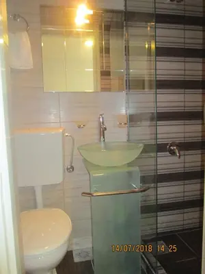 a bathroom with a sink and a toilet at Kuća Popović Apartments in Niš