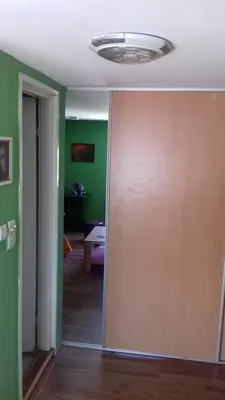 a room with green walls and a sliding door at Sweet dreams in Zaječar