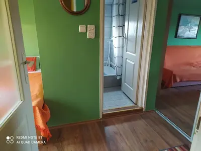 a room with a green wall and a mirror at Sweet dreams in Zaječar
