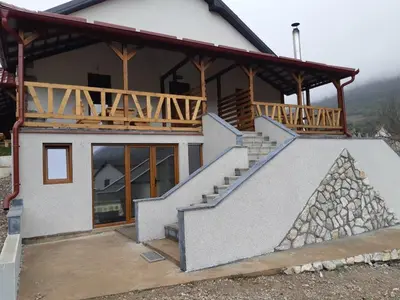 a house with a staircase in front of it at Apartmani Gmitrovic in Rtanj