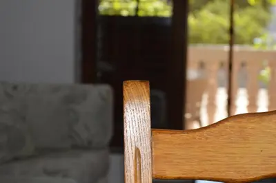 a wooden chair sitting in front of a window at Apartman Linera in Soko Banja