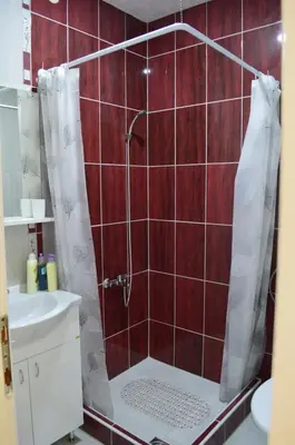 a bathroom with a shower with a toilet and a sink at Apartman Linera in Soko Banja