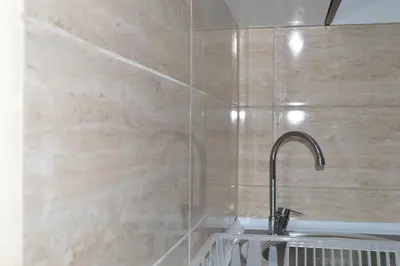 a bathroom with a shower with a sink and a faucet at Apartman Linera in Soko Banja