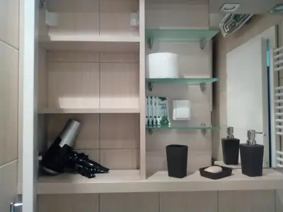 a kitchen with a shelf with wine bottles at Apartman ZVEZDA in Jagodina