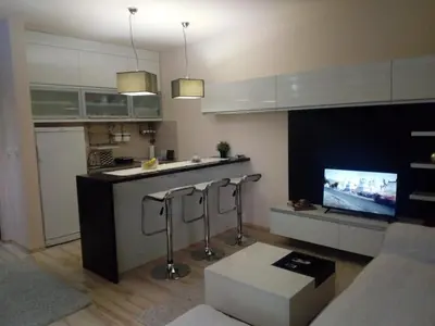 a kitchen with a bar and a tv in it at Apartman ZVEZDA in Jagodina