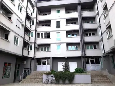 a large apartment building with stairs in front of it at Apartman ZVEZDA in Jagodina