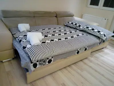 a bed with pillows on it in a room at Apartman ZVEZDA in Jagodina