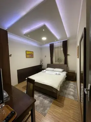 a bedroom with a bed in a room with purple lighting at DuoD in Niš