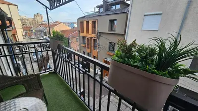 a balcony with plants inpots on a building at DuoD in Niš