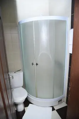 a bathroom with a toilet and a glass shower at DuoD in Niš