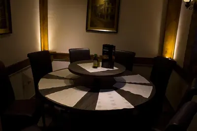 a table in a room with chairs around it at DuoD in Niš