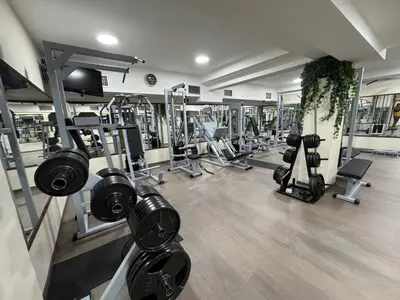 a gym with rows of treadmills and machines at DuoD in Niš