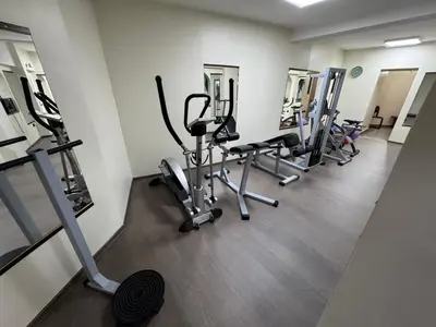 a row of treadmills and exercise bikes in a gym at DuoD in Niš
