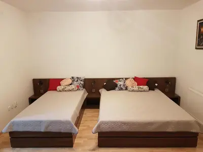 two twin beds in a room with at DM apartment in Niš