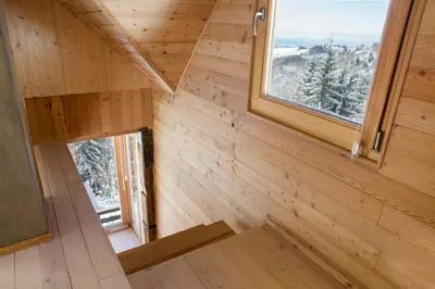 an interior view of a tiny house with two windows at Kostovac Boutique Homes - House 1 in Kopaonik