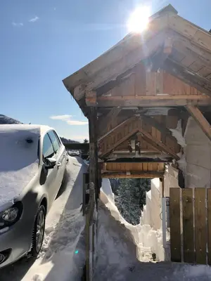 a car parked next to a building in the snow at Kostovac Boutique Homes - House 1 in Kopaonik
