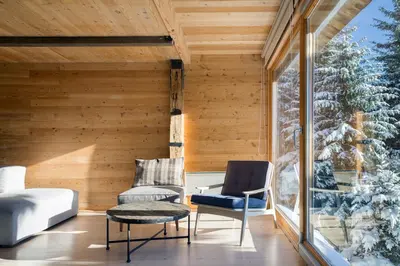 a room with a window and two chairs on a porch at Kostovac Boutique Homes - House 1 in Kopaonik
