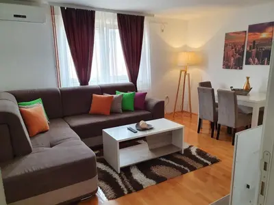 a living room with a couch and a table at Family Apartments in Zaječar