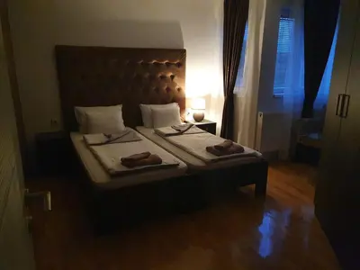 a bedroom with a bed with two towels on it at Family Apartments in Zaječar