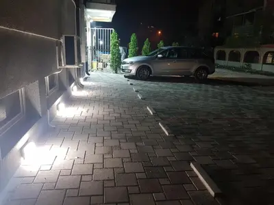 a car parked in a parking lot at night at Family Apartments in Zaječar