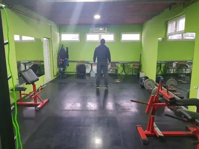 a man is standing in a room with green walls at Family Apartments in Zaječar