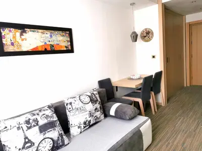 a living room with a couch and a table at Premia Apartments Konaci in Kopaonik