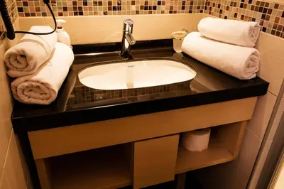 a bathroom with a sink and towels on a counter at Premia Apartments Konaci in Kopaonik