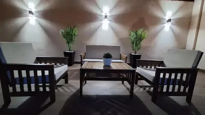a room with two chairs and a wooden table with a table sidx sidx at Apartments & Dream Rooms in Niš