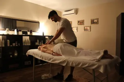a man getting a massage on a bed at Hotel Danica in Vrnjačka Banja
