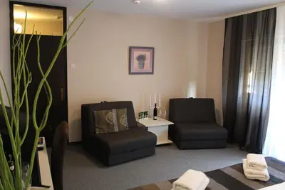 a living room with two chairs and a table at Hotel Danica in Vrnjačka Banja