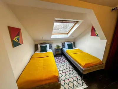 two beds in a small room with a window at THE ONLY ONE Accommodation in Niš