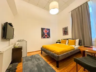 a bedroom with a bed and a tv in it at THE ONLY ONE Accommodation in Niš