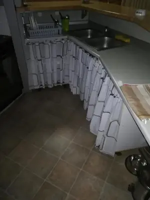 a kitchen with a sink and a counter with paper towels at Apartmani DiO in Niš