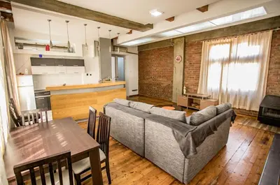 a living room with a couch and a table at Apartmani DiO in Niš