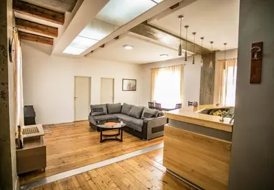 a living room with a couch and a table at Apartmani DiO in Niš