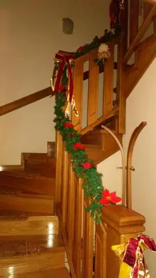 a stairway with a christmas garland on it at Apartmani Nik Lux in Vrnjačka Banja