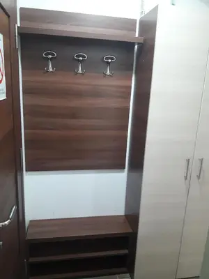 a closet with wood and metal knobs on it at Apartmani Nikola u vili Semeteš in Kopaonik