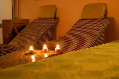 two beds with candles on them in a room at IWA CENTAR Apartments & Wellness in Vrnjačka Banja