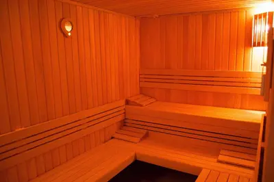a wooden sauna with a wooden bench in it at IWA CENTAR Apartments & Wellness in Vrnjačka Banja