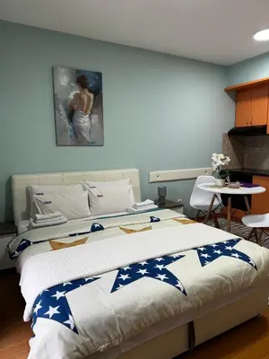 a bedroom with two beds and a painting on the wall at IWA CENTAR Apartments & Wellness in Vrnjačka Banja