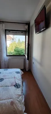 an empty room with a bed and a window at Ćele-kula Apartment in Niš