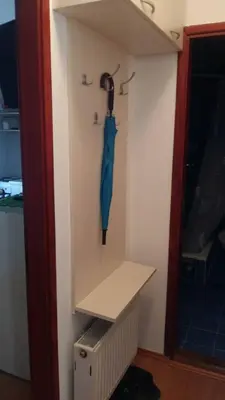 a blue umbrella hanging on a wall next to a door at Ćele-kula Apartment in Niš