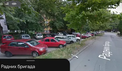 a row of cars parked on the side of a street at Ćele-kula Apartment in Niš
